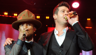 Pharrell Williams and Robin Thicke singing together. 